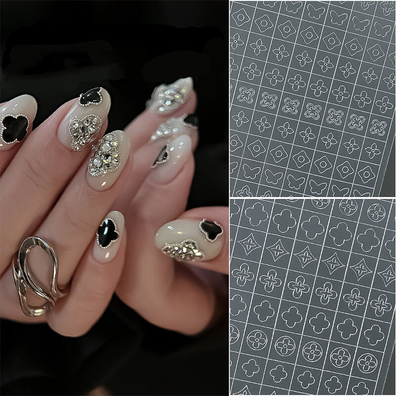 Nail art with decorative elements and a patterned overlay