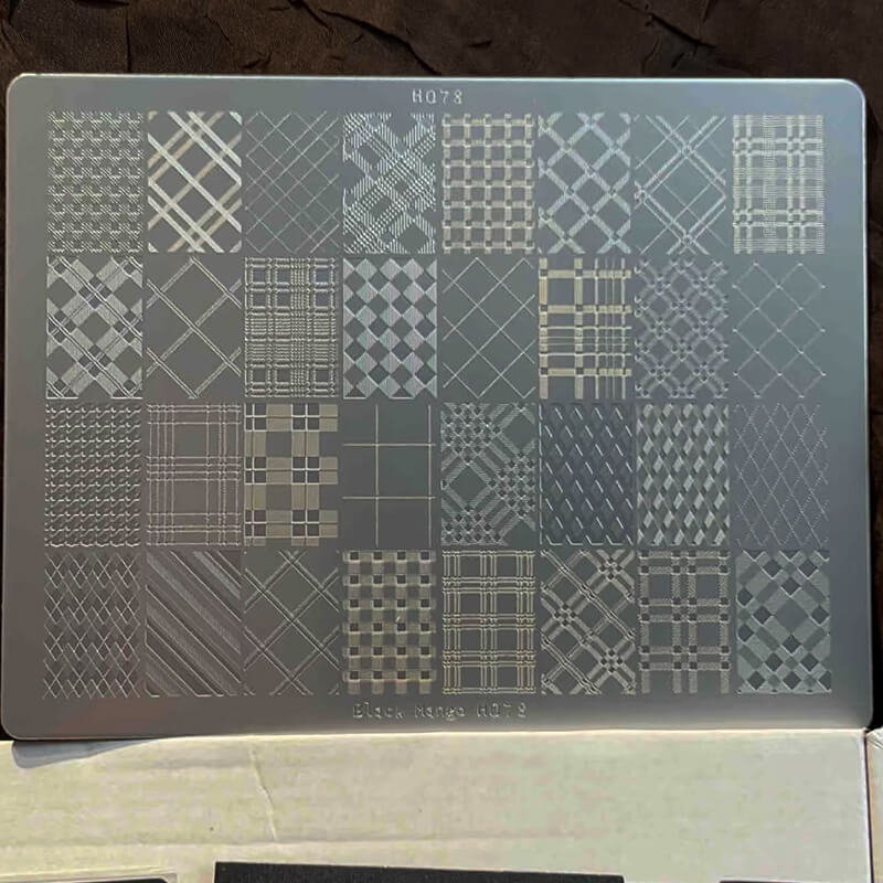 Stamping plate with geometric patterns on a dark background