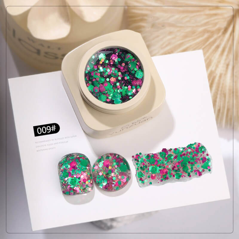 Colorful glittery nail art set with a container on a white background