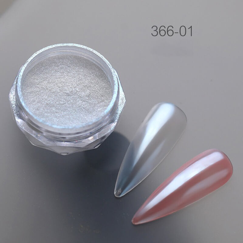 Silver glitter in a jar with a nail displaying the color on a gray background