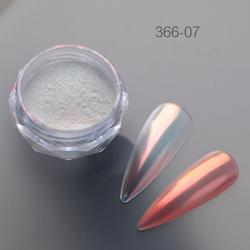 Nail art powder in a small container with a nail sample on a gray background