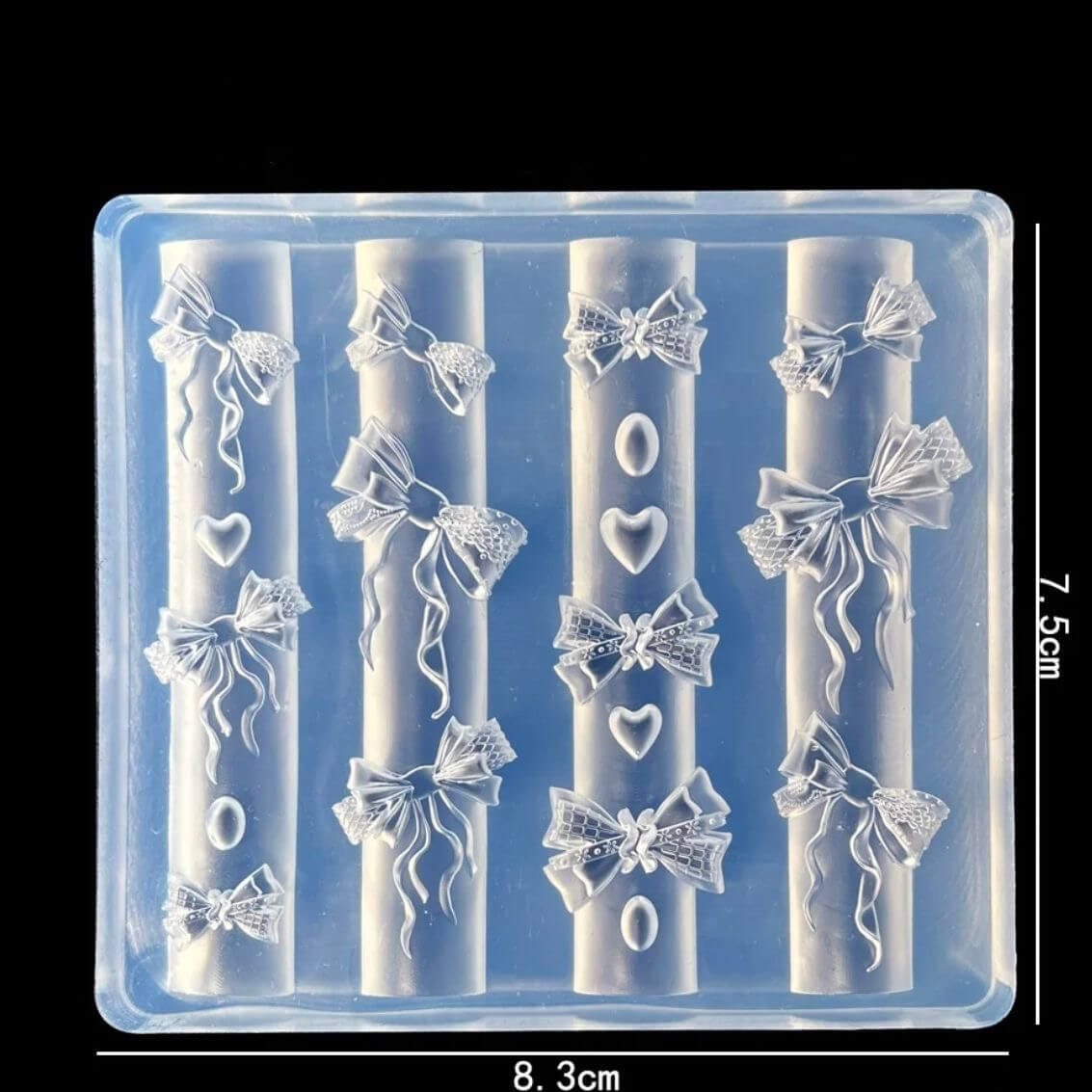 Clear silicone mold with bow and heart designs on a black background