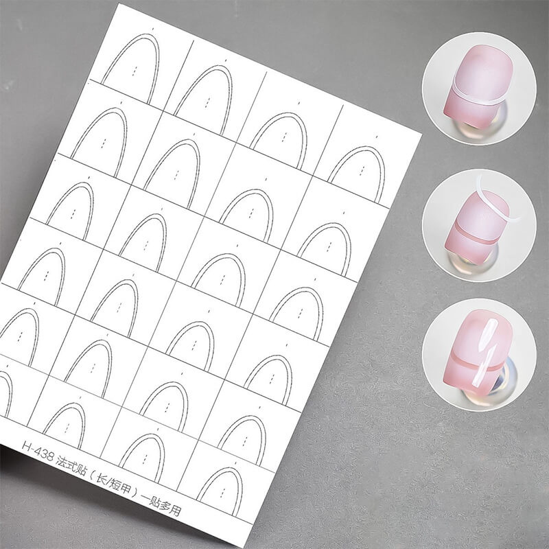 Sheet of nail art design templates with three completed nail designs on a gray surface.