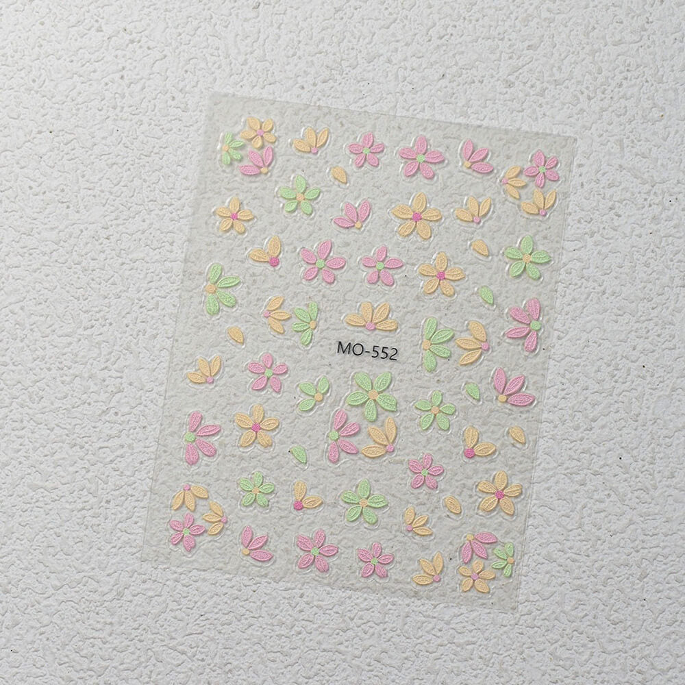 Sheet of colorful flower-shaped stickers on a textured gray background