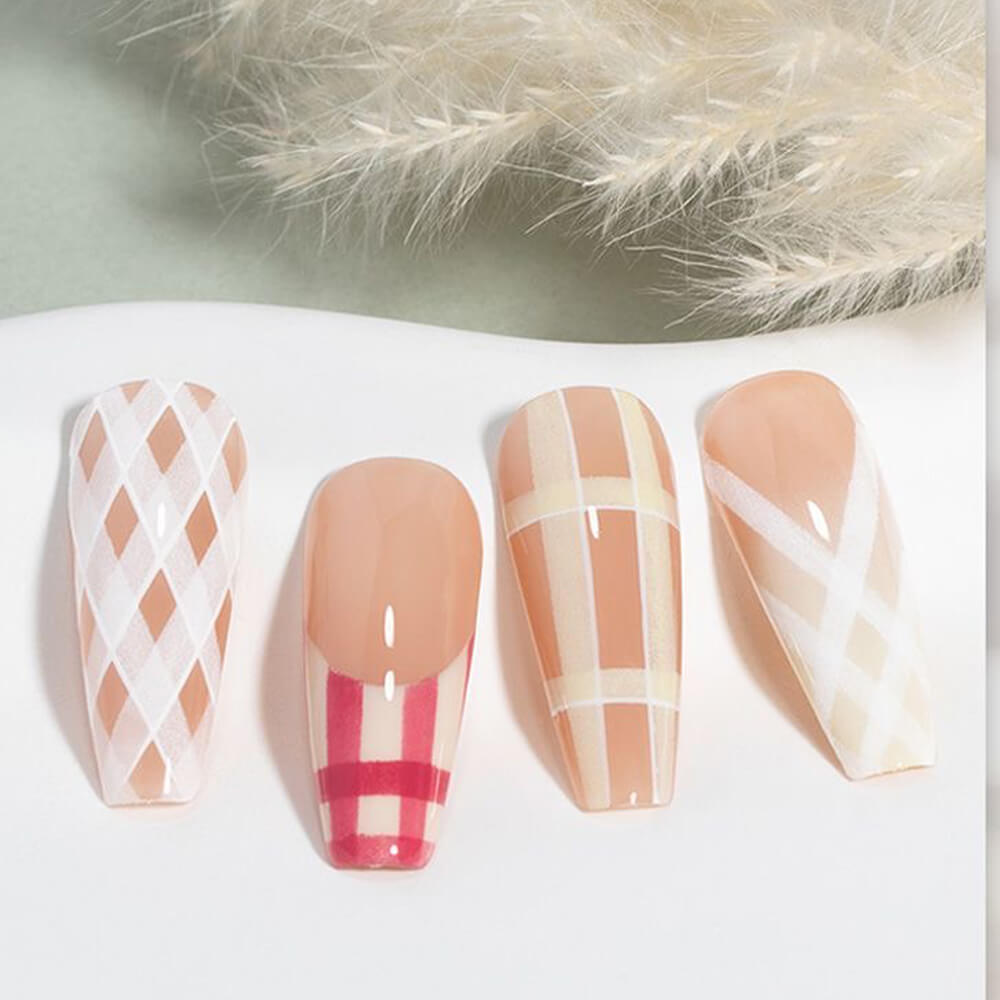 Four nail designs with geometric patterns on a white surface.