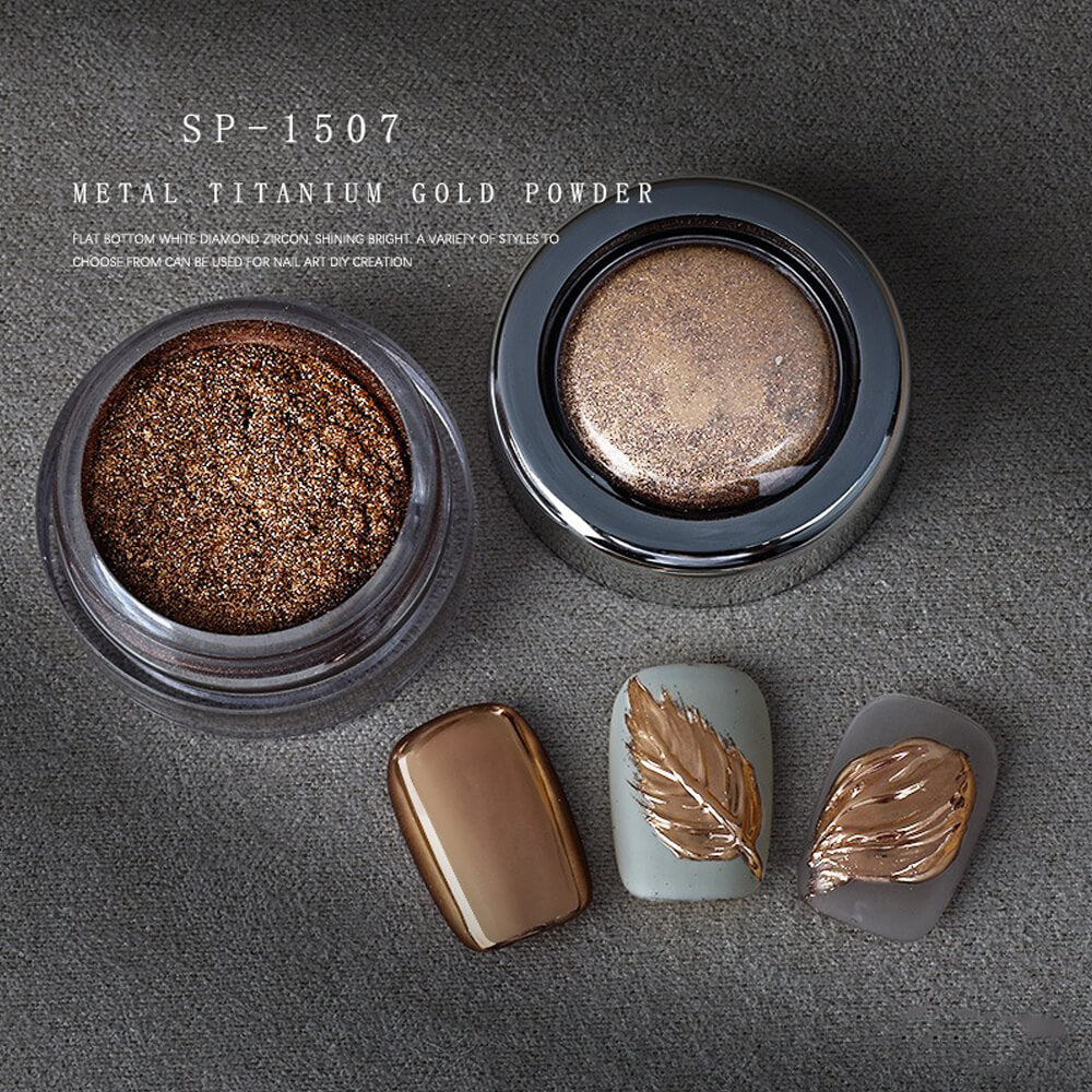 Metallic titanium gold powder in a container with nail art designs on a gray background