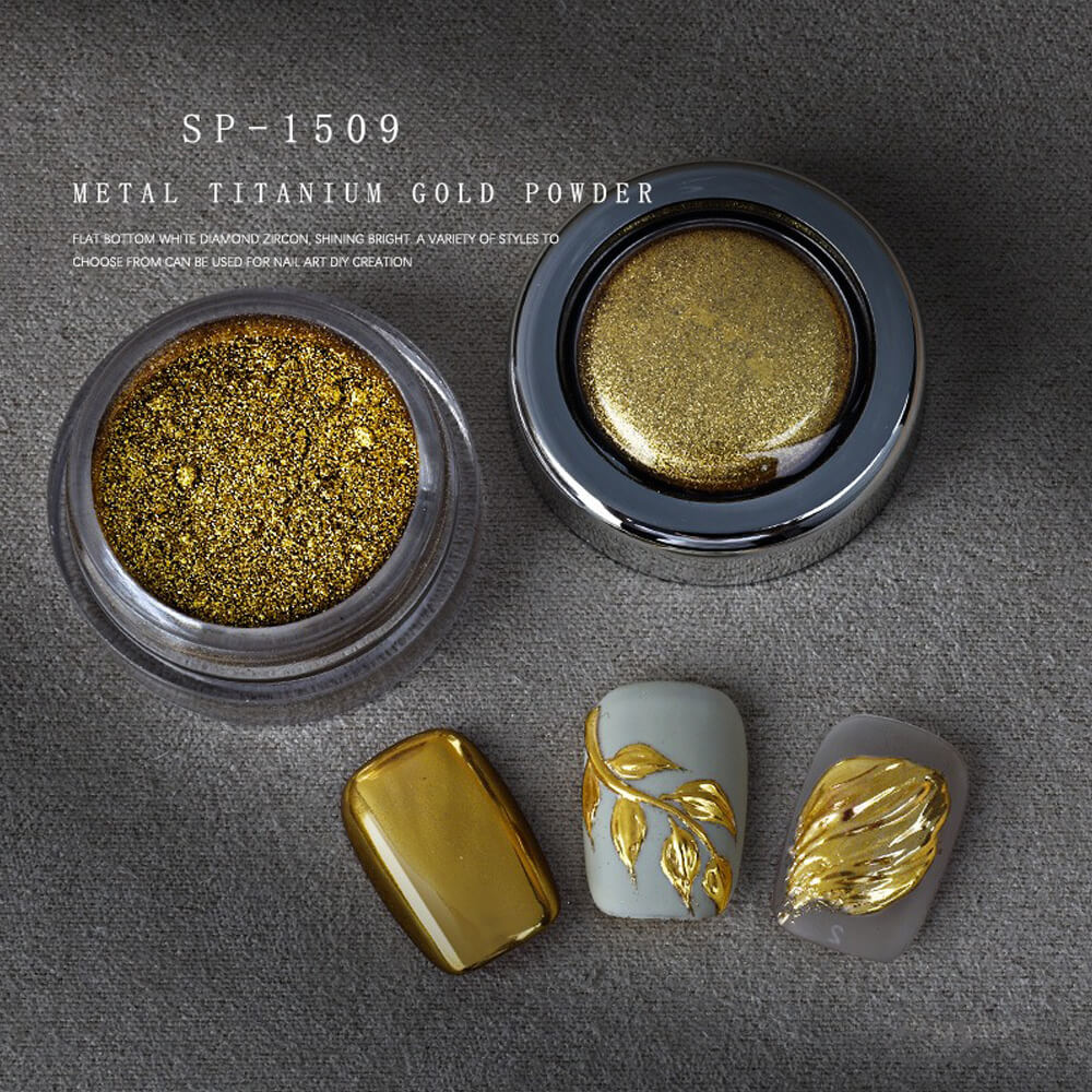 Metallic titanium gold powder in a container with nail art designs on a gray background