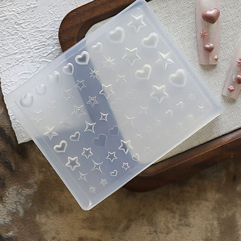 Silicone mold with heart and star shapes on a textured surface