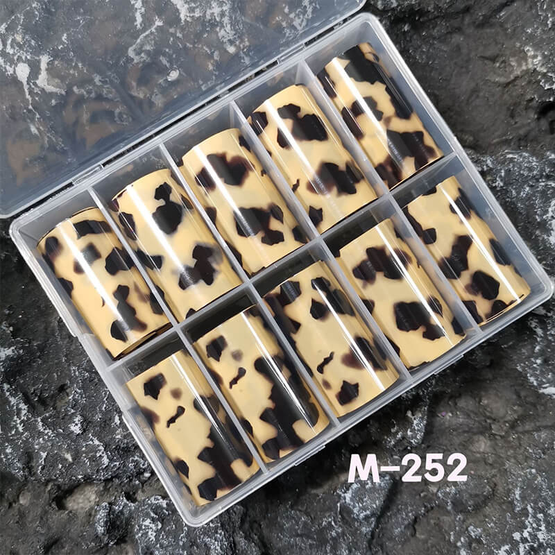 Leopard print nail transfer foil on a dark stone surface