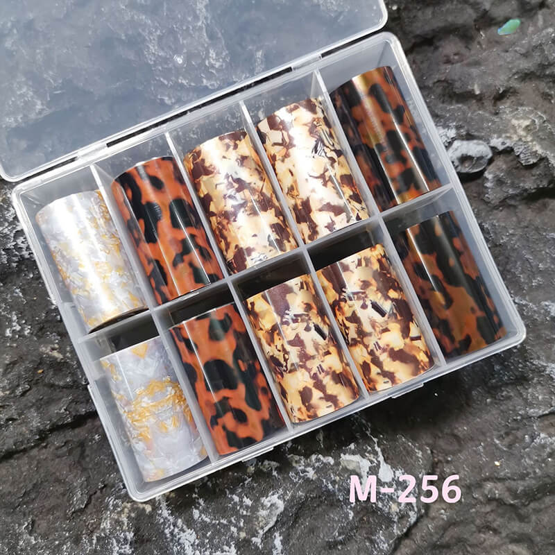 Tortoiseshell amber marble flame nail foil sheet showing warm brown and gold swirling patterns.