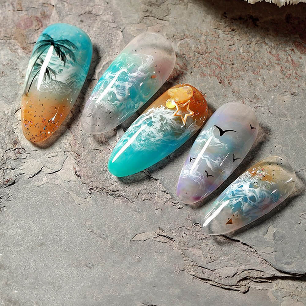 Hand model wearing ocean wave nail art with white blooming gel on blue base