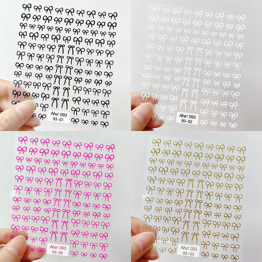 A set of nail art stickers in various colors, each featuring a pattern of small, interconnected bow shapes.