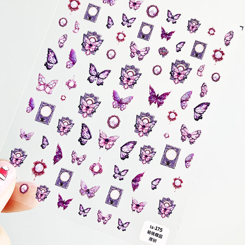 A sheet of nail art stickers with various butterfly designs in pink, purple, and white colors.
