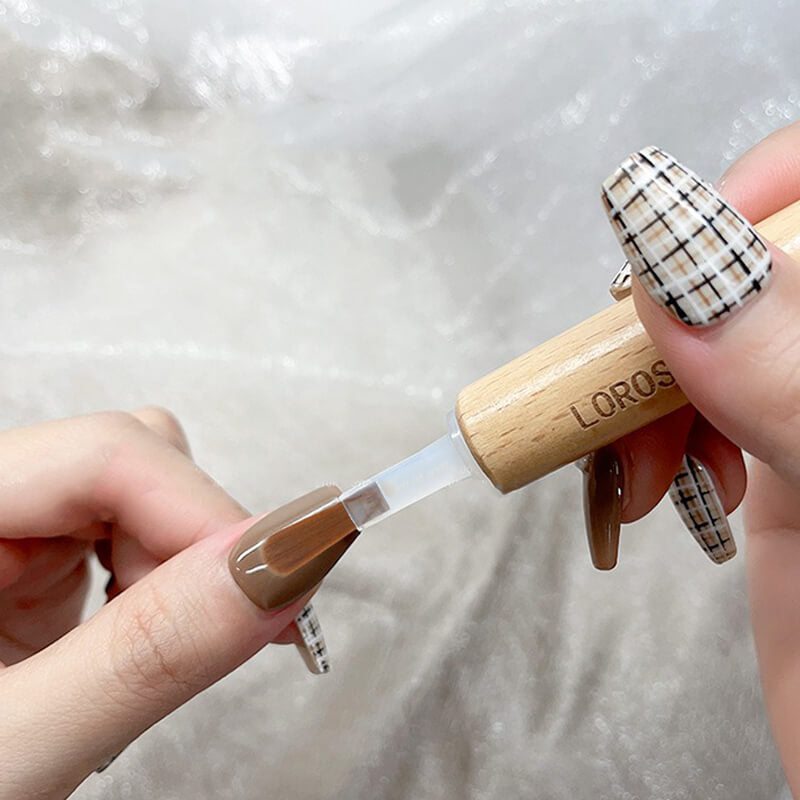 Double-ended handle with brush head attached creating detailed nail art design