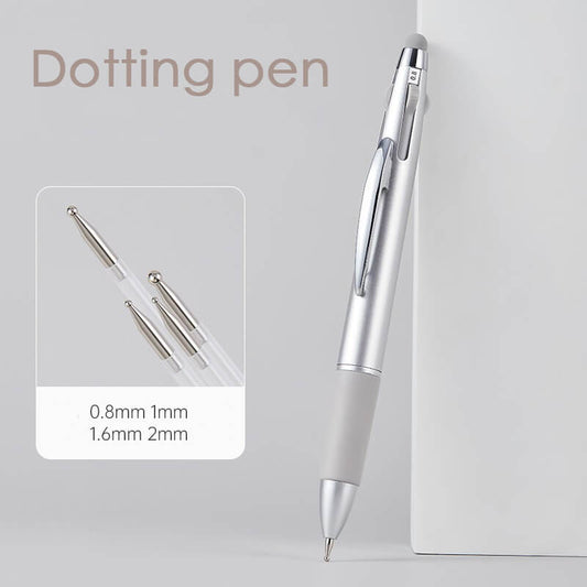 A set of four nail dotting pens with different sized tips laying on a white surface, the pens are silver in color with a cap on one end.