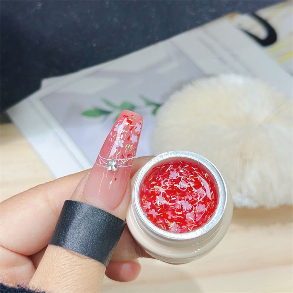 Cherry blossom glitter gel polish bottle with pink and white glitter particles suspended in clear gel