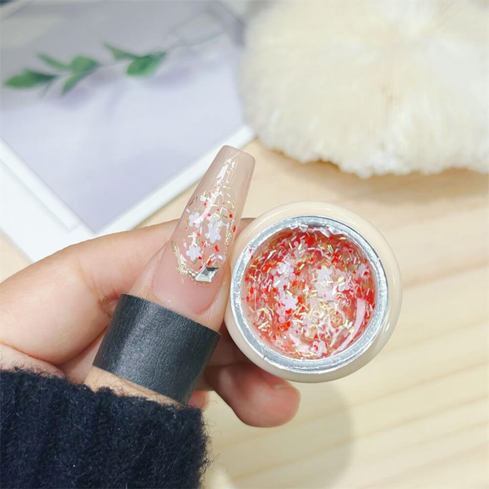 Cherry blossom glitter gel polish bottle with pink and white glitter particles suspended in clear gel