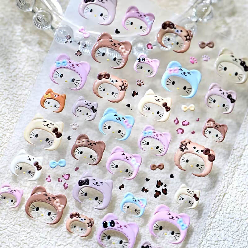 Collection of colorful cat-themed decorative items on a textured surface