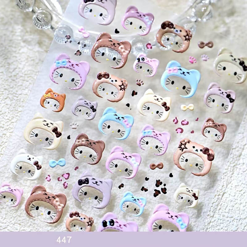 Cartoon kitty embossed nail sticker sheet featuring multiple 3D cat head designs in assorted colors.