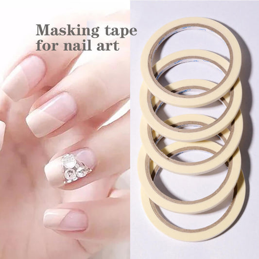 A stack of beige-colored paper tapes designed for nail masking, with one tape applied to a person's nail to demonstrate its use.