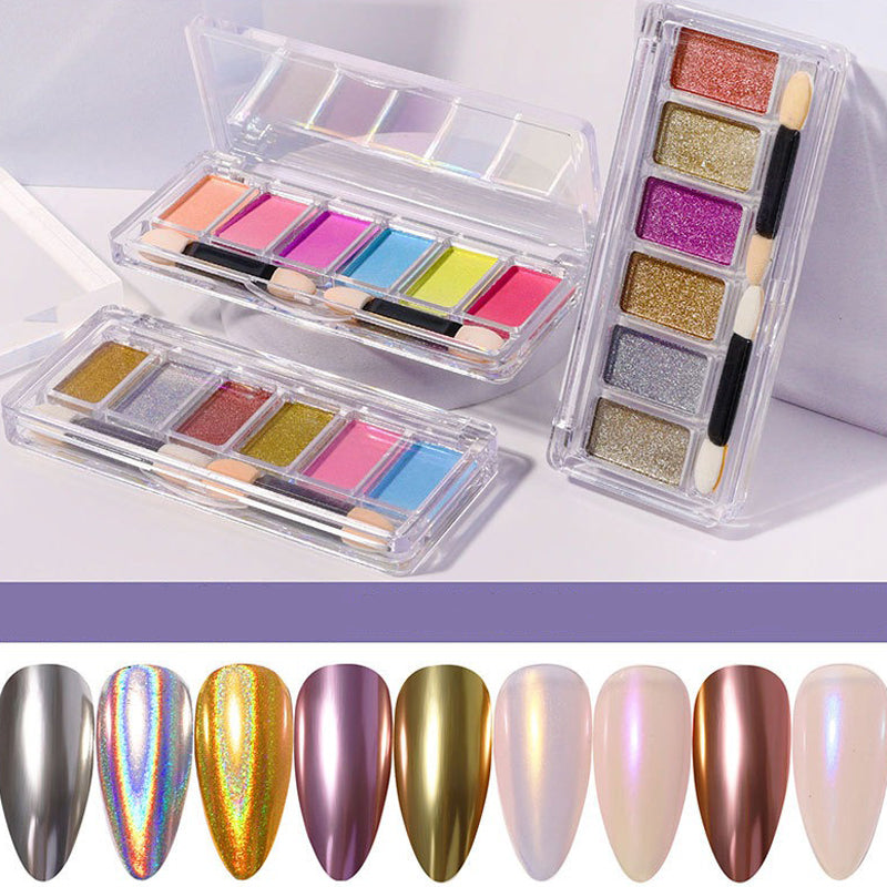 A set of nail powder samples displayed in a grid arrangement, showing various metallic and mirror-effect pigments in a clear plastic case.
