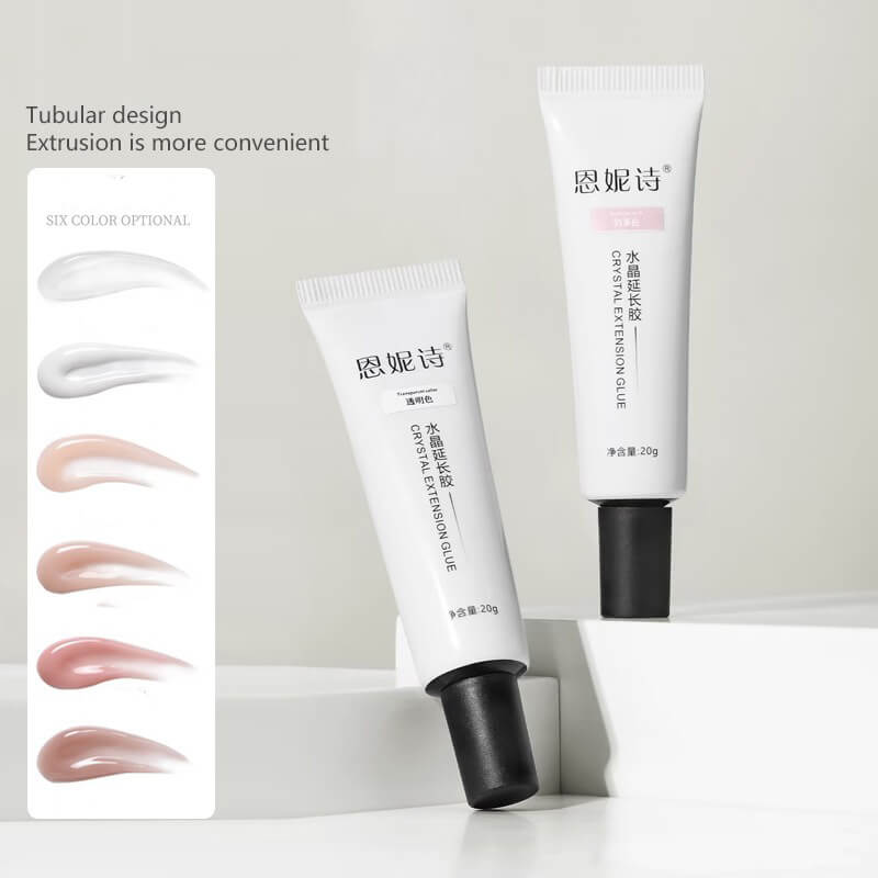 Two white tubes with black caps and a box displaying color swatches on a light gray background.