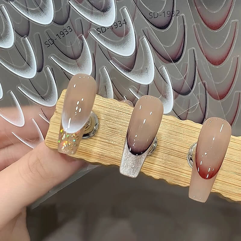 Hand model wearing ombre French gradient stickers on natural base for elegant look