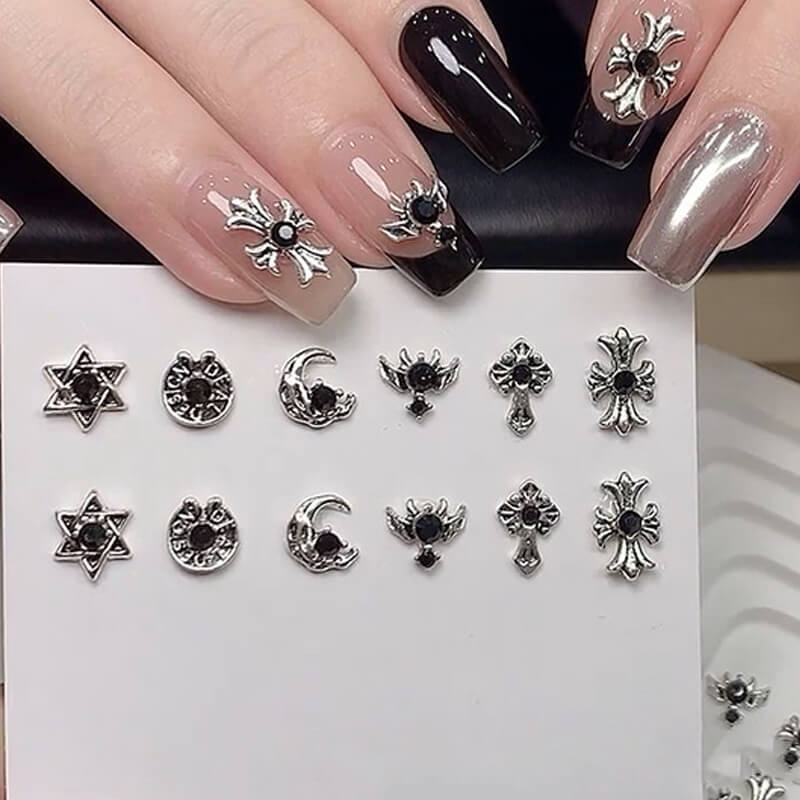 Assorted punk black alloy nail charms including Gothic crosses and chrome heart metal studs.
