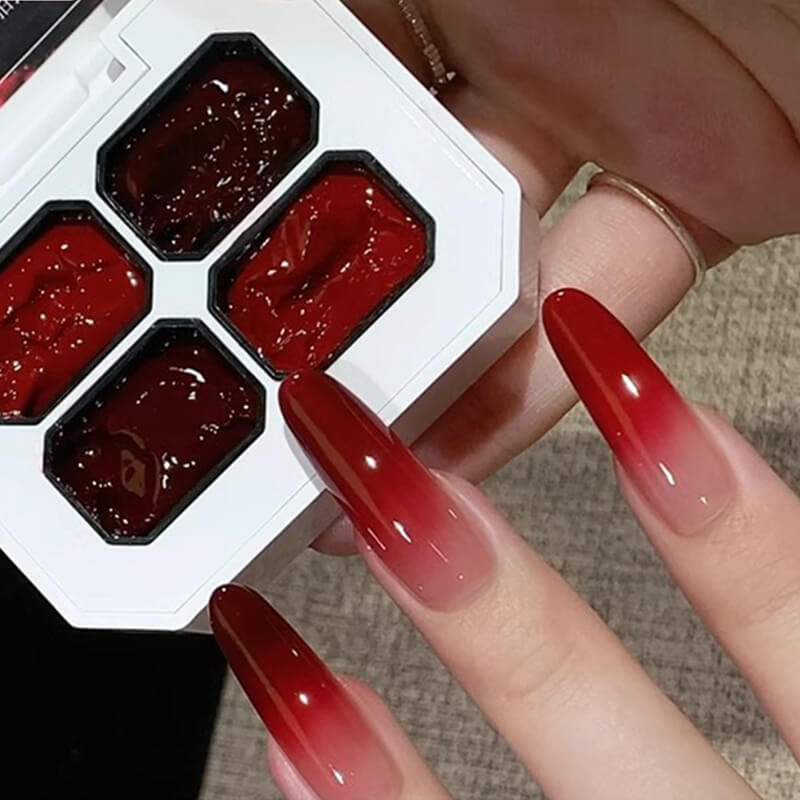 Hand model wearing French tips and floral details created with red painting gel