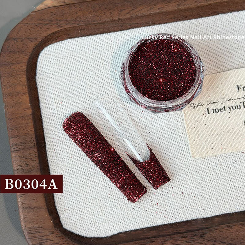 Jar of ultra sparkly red nail glitter powder with crushed diamond effect shimmer visible.