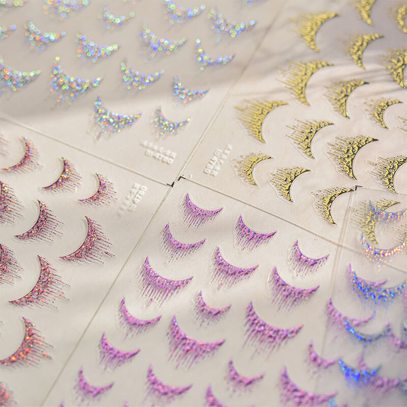 Close-up of silver tassel sticker showing detailed fringe strands and metallic shine