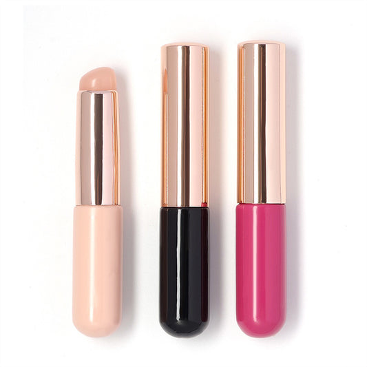 Three silicone nail art brushes in different colors, with a rose gold-colored cap on each.