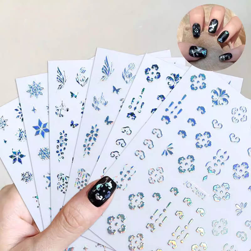 A set of nail art stickers with various designs including snowflakes and butterflies, primarily in silver and blue colors.
