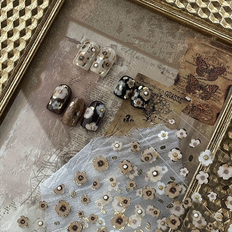 Close-up of raised 3D flower design with gold highlights on black base