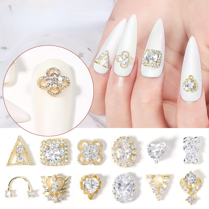 A collection of various 3D shiny zircon rhinestone nail decorations, including diamond-shaped and other ornamental designs, intended for nail art.