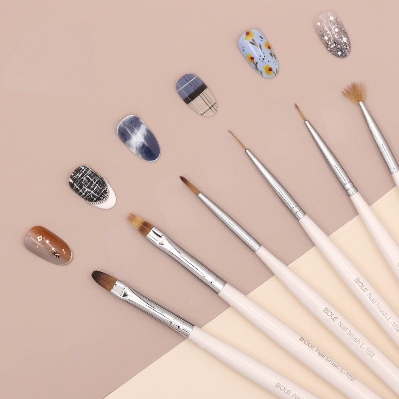 A set of 6 nail art brushes with different sizes and shapes displayed alongside a collection of nail polish colors and a swatch of gel polish.